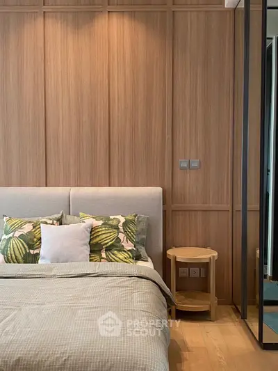 Modern bedroom with stylish wooden paneling and cozy bedding
