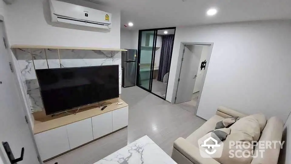 Modern living room with sleek TV unit and comfortable sofa in stylish apartment