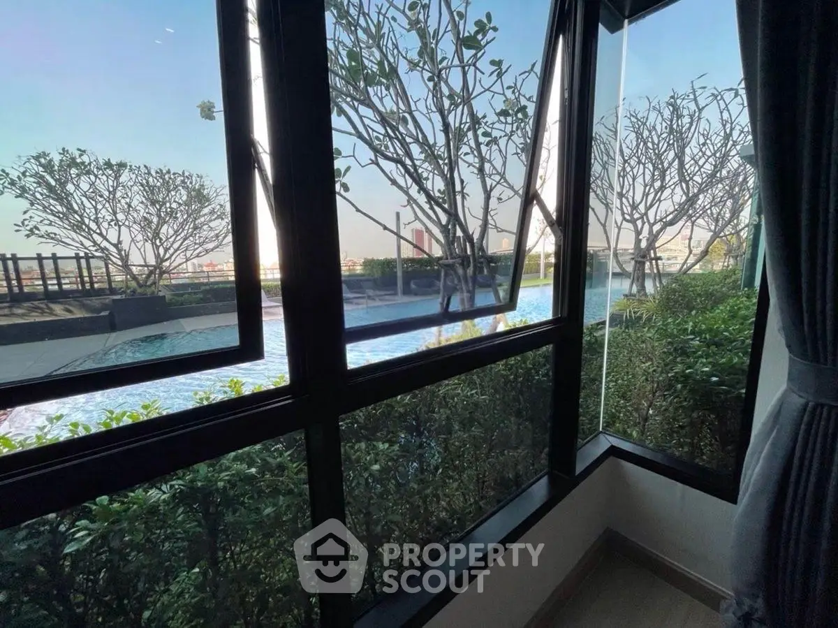 Stunning poolside view from a modern window, showcasing lush greenery and serene outdoor ambiance.