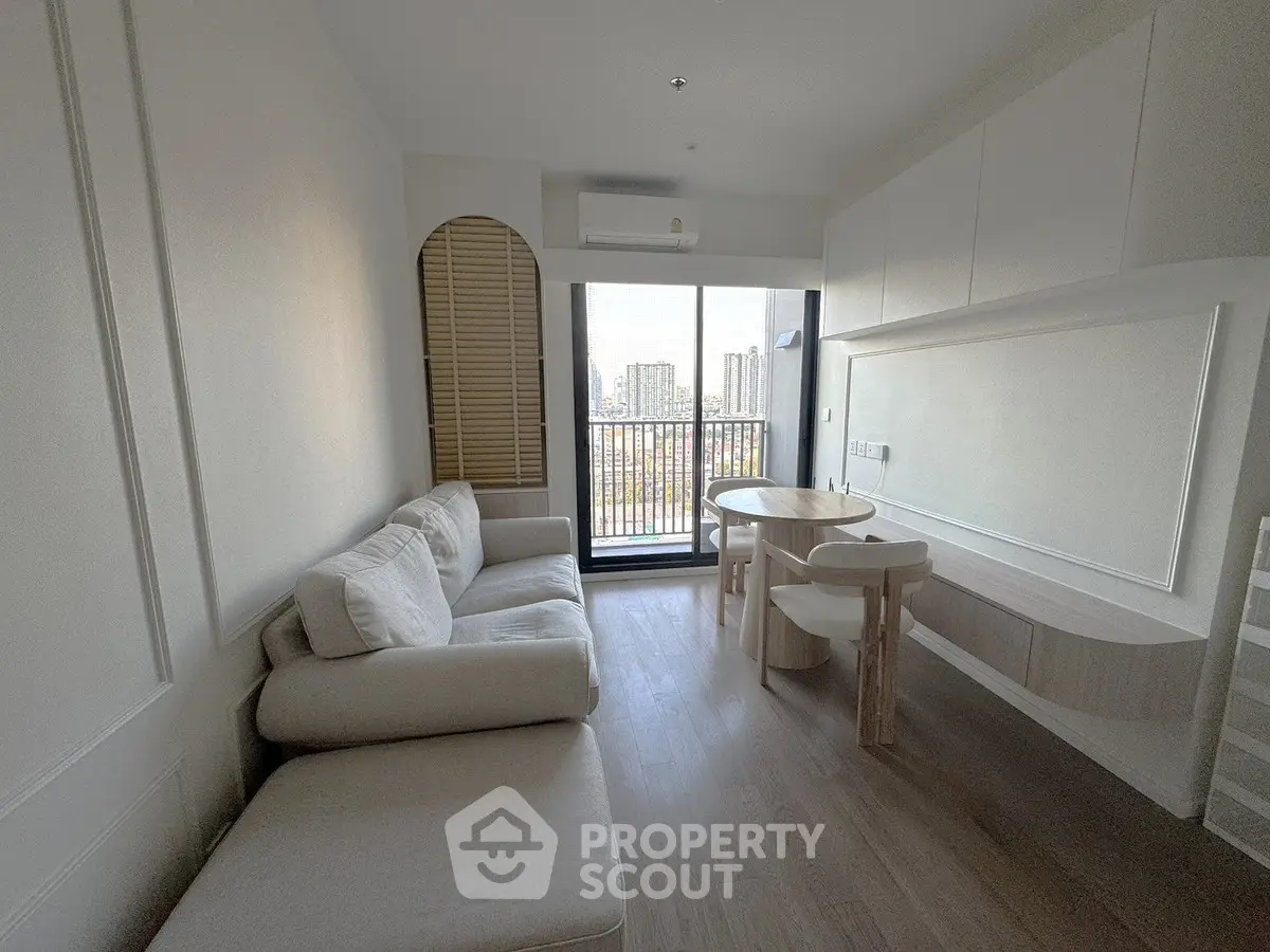 Modern living room with cozy sofa and city view balcony in a stylish apartment.