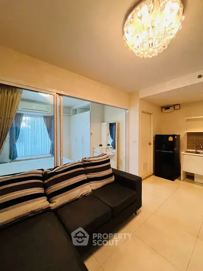 Modern living room with elegant lighting and cozy striped sofa