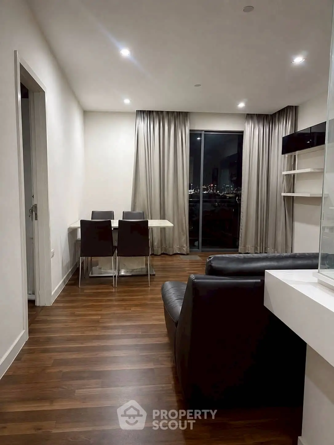 Modern living room with sleek furniture and city view, perfect for urban living.