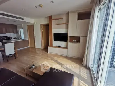 Spacious modern living room with open kitchen and natural light