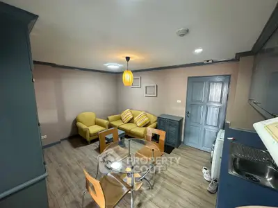 Cozy living room with modern furniture and dining area in stylish apartment.