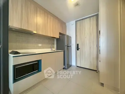 Modern kitchen with sleek cabinetry and stainless steel appliances in a compact layout.