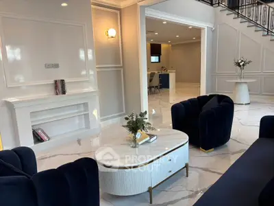 Luxurious living room with elegant navy sofas and marble flooring