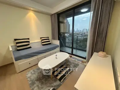 Chic living room with city view balcony, cozy seating, and modern decor.