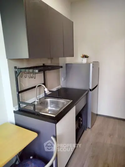 Compact modern kitchen with sleek cabinets and stainless steel appliances