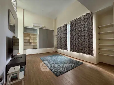 Spacious living room with modern decor and large windows