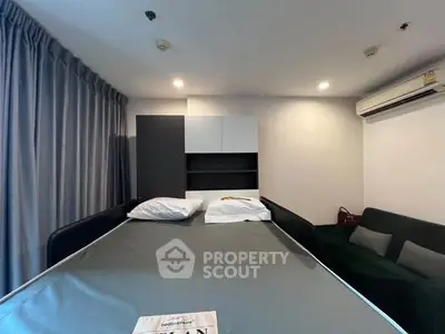 Modern bedroom with sleek design and air conditioning in a cozy apartment.