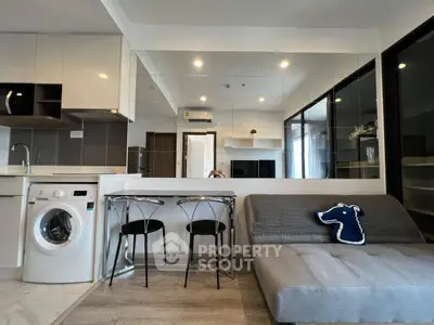 Modern living room with sleek furniture and built-in washing machine, perfect for urban living.