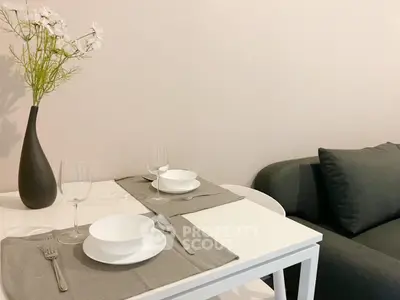 Cozy dining nook with elegant table setting and modern sofa