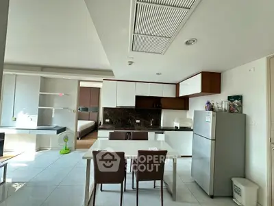 Modern open-layout kitchen and dining area with sleek design and natural light