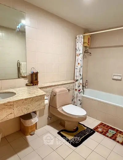 Spacious bathroom with elegant marble countertop and bathtub in modern apartment.