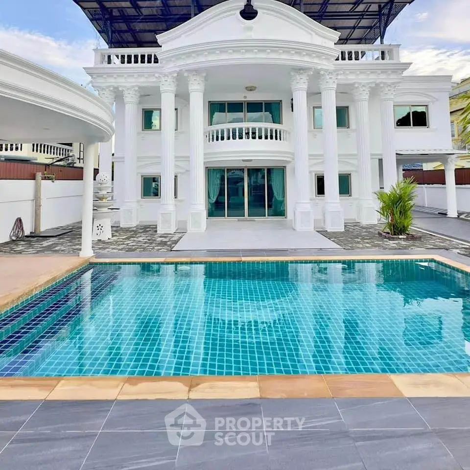 Luxurious mansion with grand columns and private pool, perfect for upscale living.