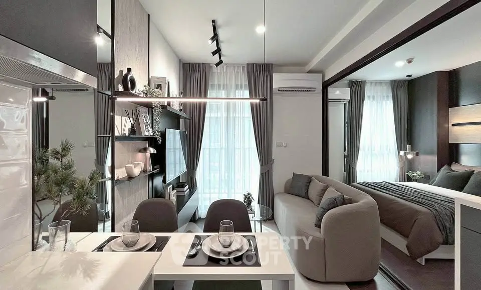 Modern open-plan living room and bedroom with stylish decor and natural light