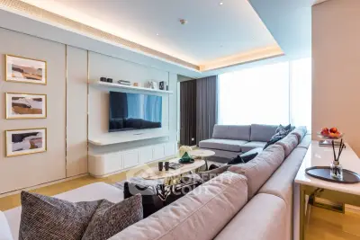 Luxurious modern living room with large sectional sofa and wall-mounted TV, perfect for relaxation and entertainment.
