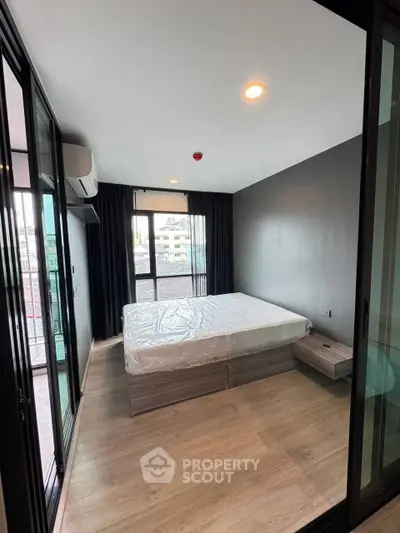 Modern bedroom with large windows and city view in a stylish apartment