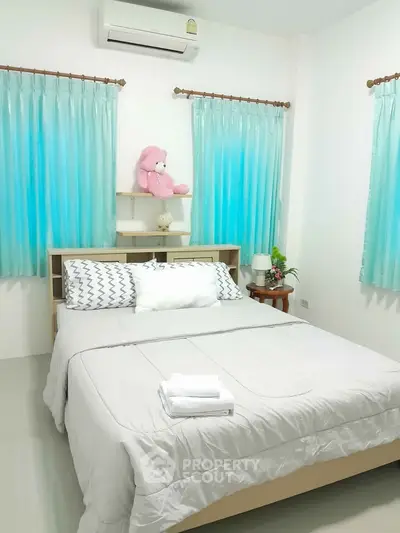 Cozy bedroom with plush bedding and soft lighting, perfect for relaxation.