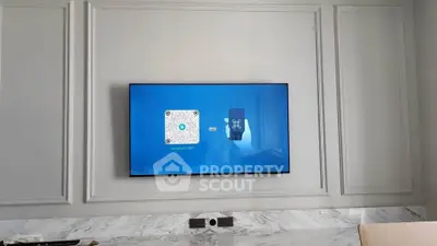 Modern living room with wall-mounted TV and elegant paneling