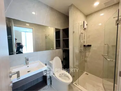 Modern bathroom with glass shower and sleek fixtures