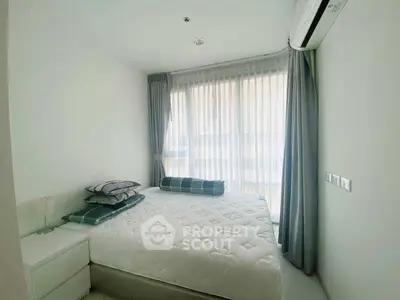 Bright and cozy bedroom with large window and modern decor