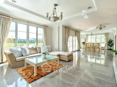 Spacious and elegant living room with large windows and modern decor