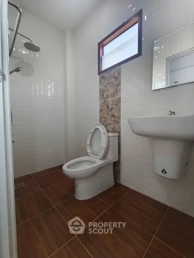 Modern bathroom with sleek fixtures and stylish tile design, perfect for a contemporary home.