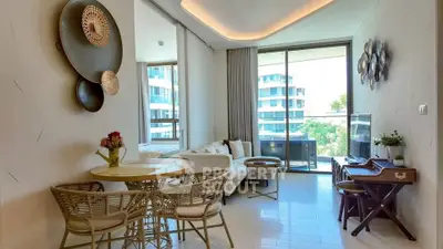 Stylish living room with modern decor and large windows offering a scenic view, perfect for relaxation.
