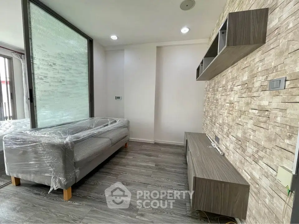 Modern living room with stylish stone accent wall and sleek furniture