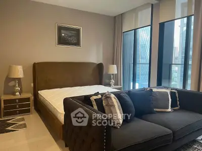 Luxurious bedroom with modern decor and city view, featuring a plush bed and elegant sofa.