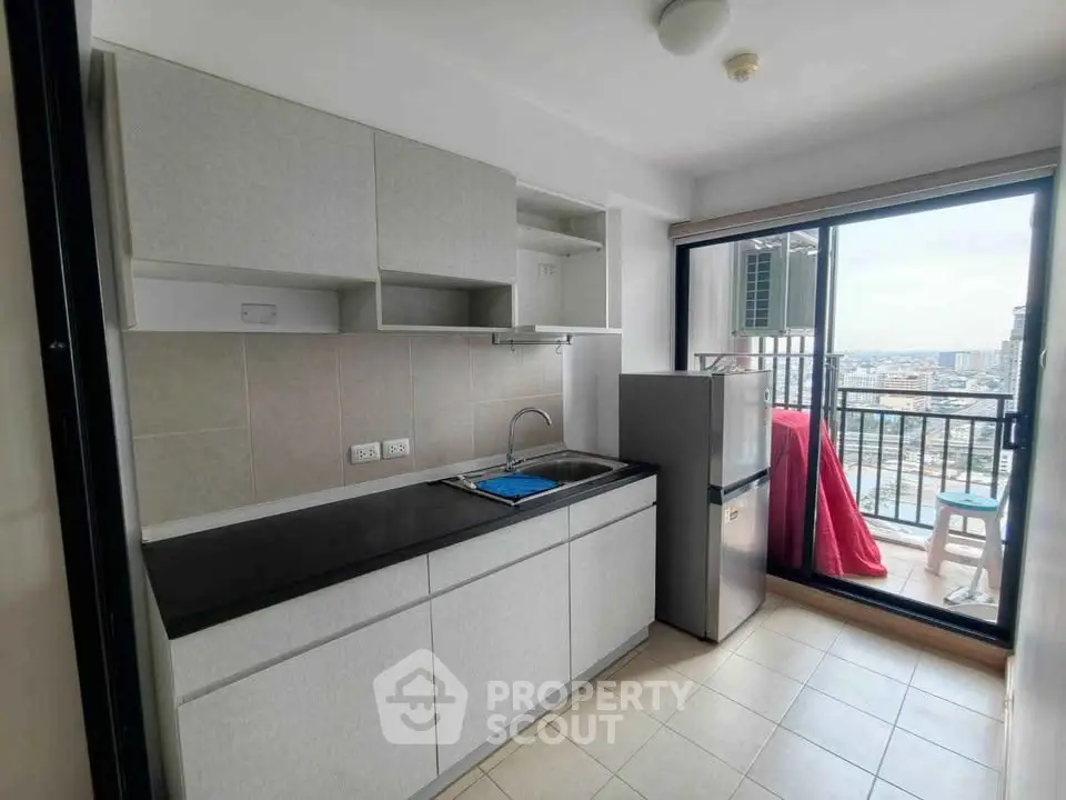 Modern kitchen with balcony view in high-rise apartment