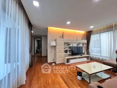 Spacious living room with wooden flooring and modern entertainment center