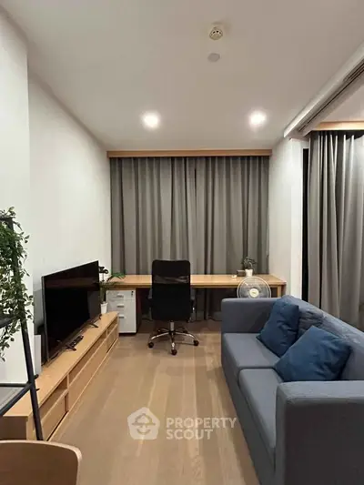 Modern living room with sleek furniture and cozy ambiance, featuring a stylish desk and comfortable sofa.