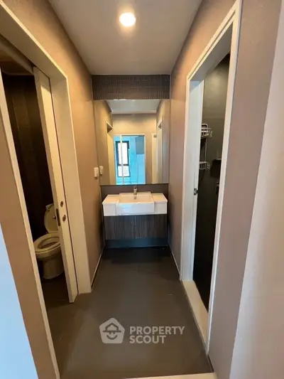 Modern bathroom with sleek design and dual sinks in a contemporary apartment.