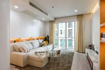 Modern living room with cozy sectional sofa and large windows in a stylish apartment.
