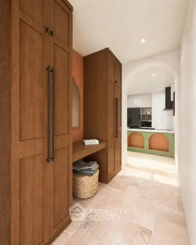 Charming hallway with wooden cabinets leading to a modern kitchen with archway entrance.