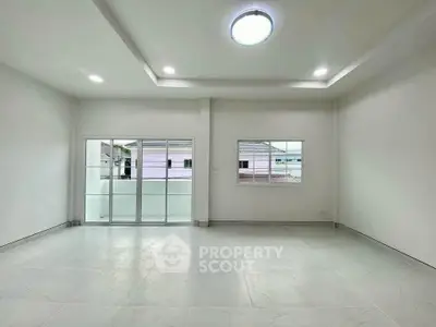 Spacious and bright living room with modern ceiling lights and large windows for natural light.
