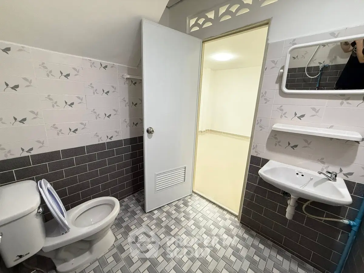 Modern bathroom with stylish tile design and compact fixtures