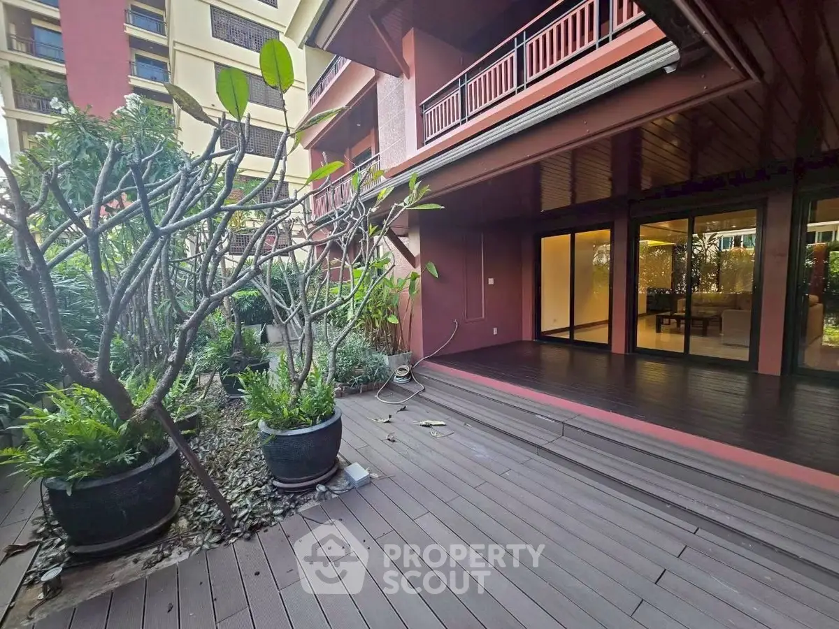 Spacious garden terrace with lush greenery and modern wooden decking