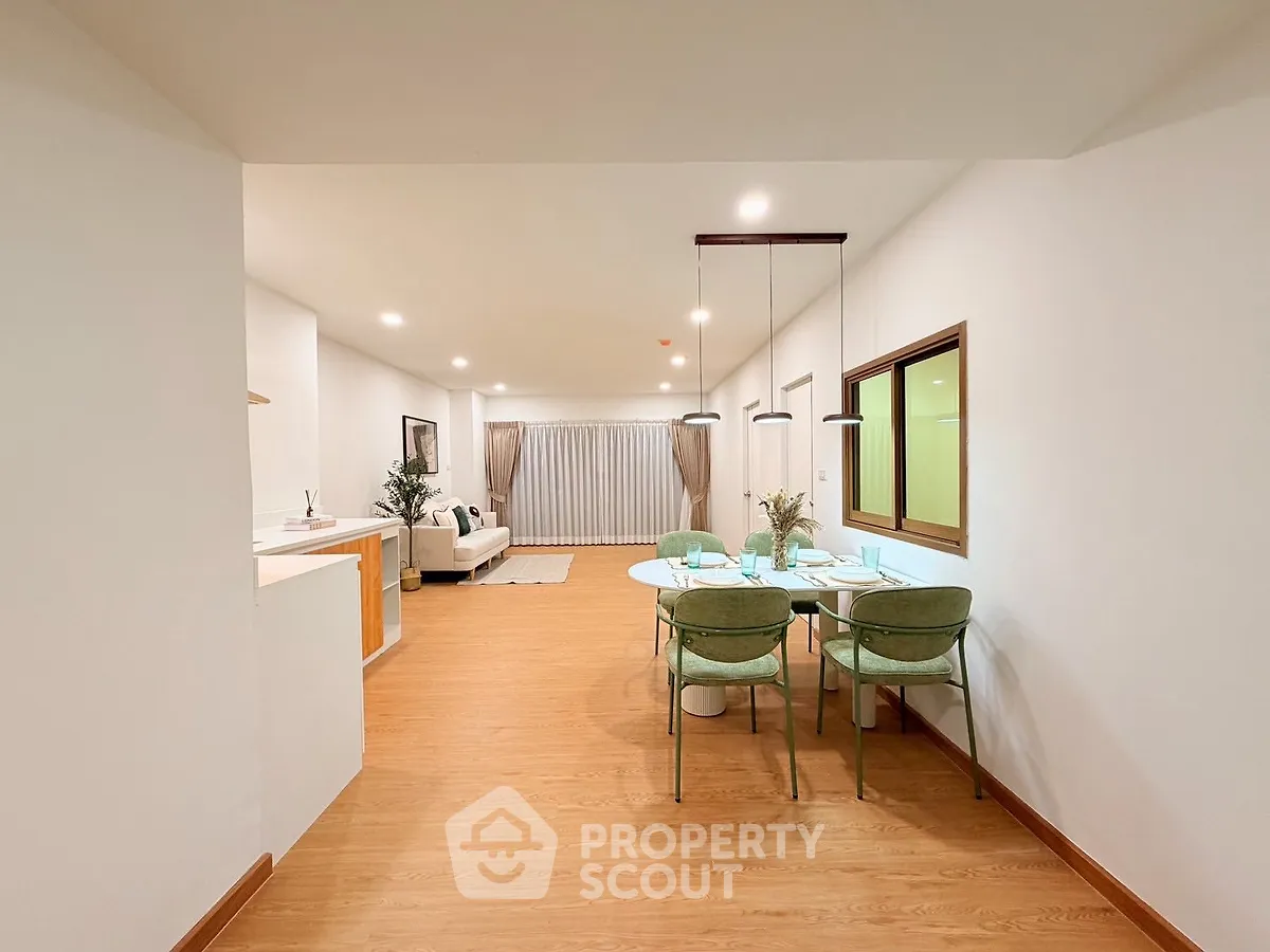 Spacious open-plan living and dining area with modern decor and ample natural light.
