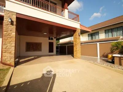 Spacious modern home with covered carport and stone accents, perfect for family living.