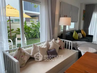 Charming living room with cozy seating and garden view, perfect for relaxation and entertaining.