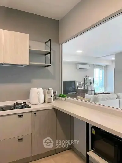 Modern kitchen with open layout and sleek appliances in a stylish apartment