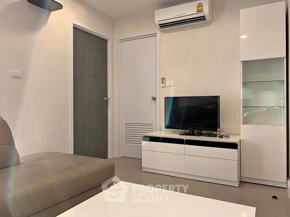 Modern living room with sleek furniture and air conditioning