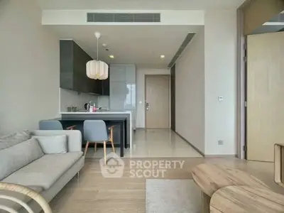 Modern open-plan living room with stylish kitchen and cozy seating area.