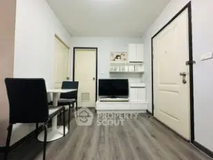Modern living room with sleek furniture and stylish flooring in a cozy apartment.