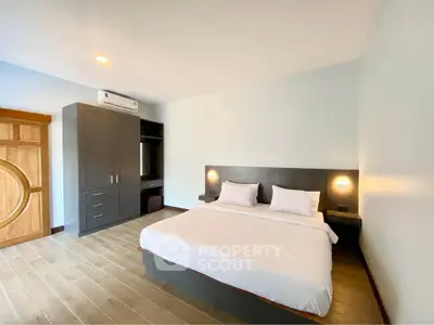 Spacious modern bedroom with elegant furnishings and ample natural light