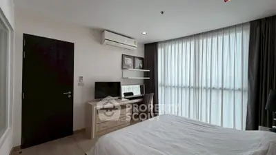 Modern bedroom with large window, air conditioning, and stylish furniture in a contemporary apartment.