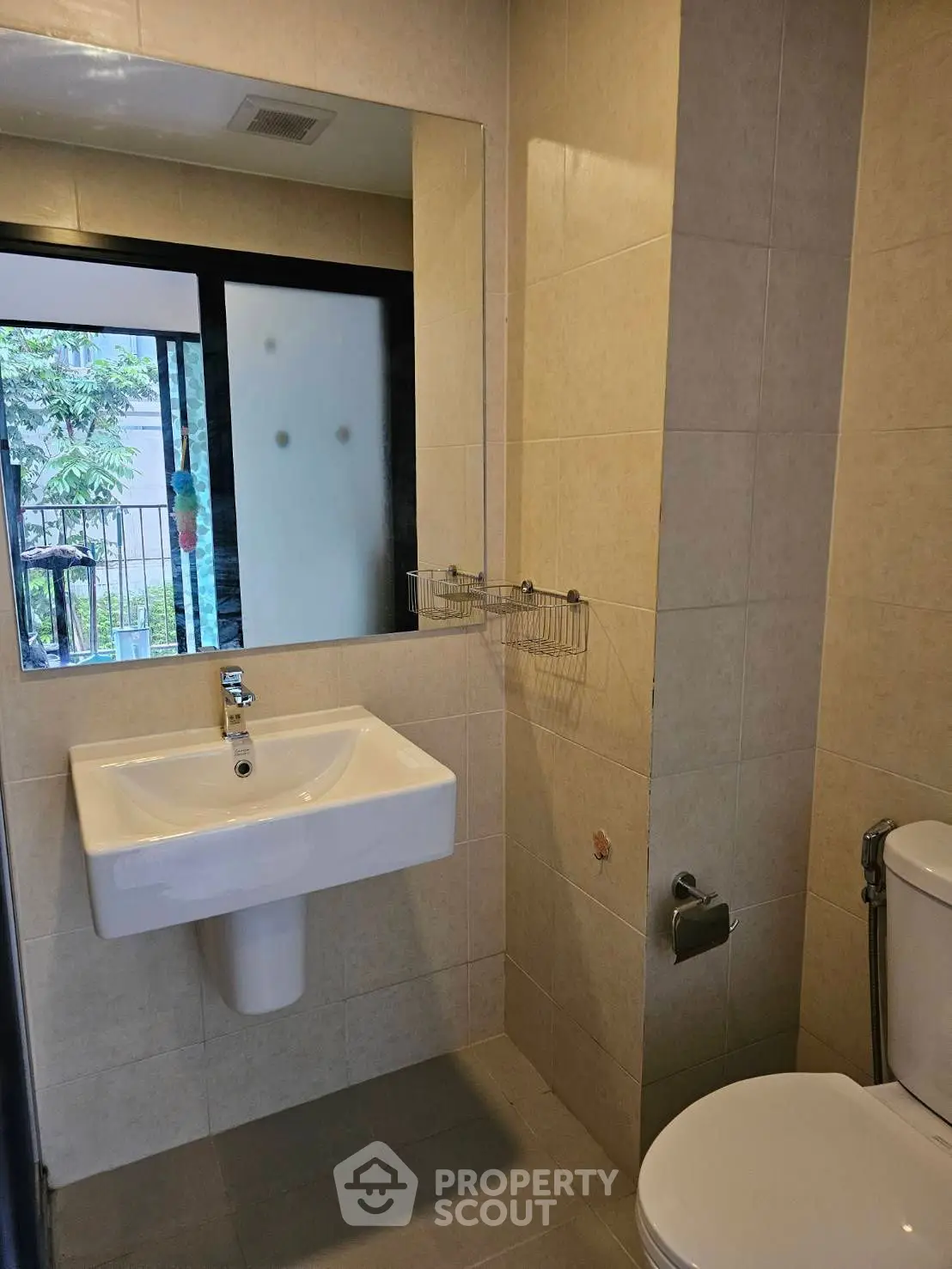 Modern bathroom with sleek fixtures and outdoor view through frosted window.
